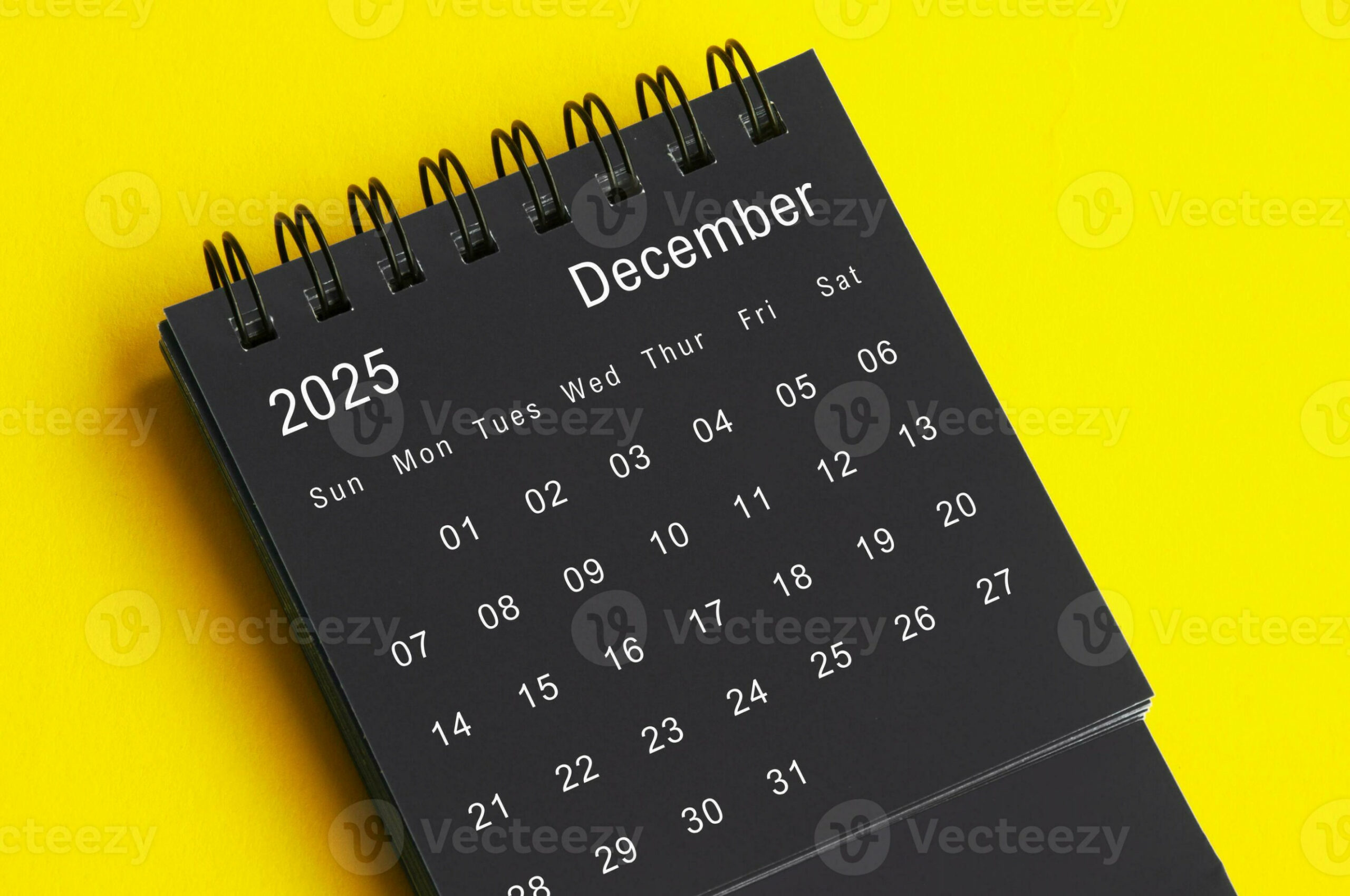 December  black and white desk calendar on yellow cover