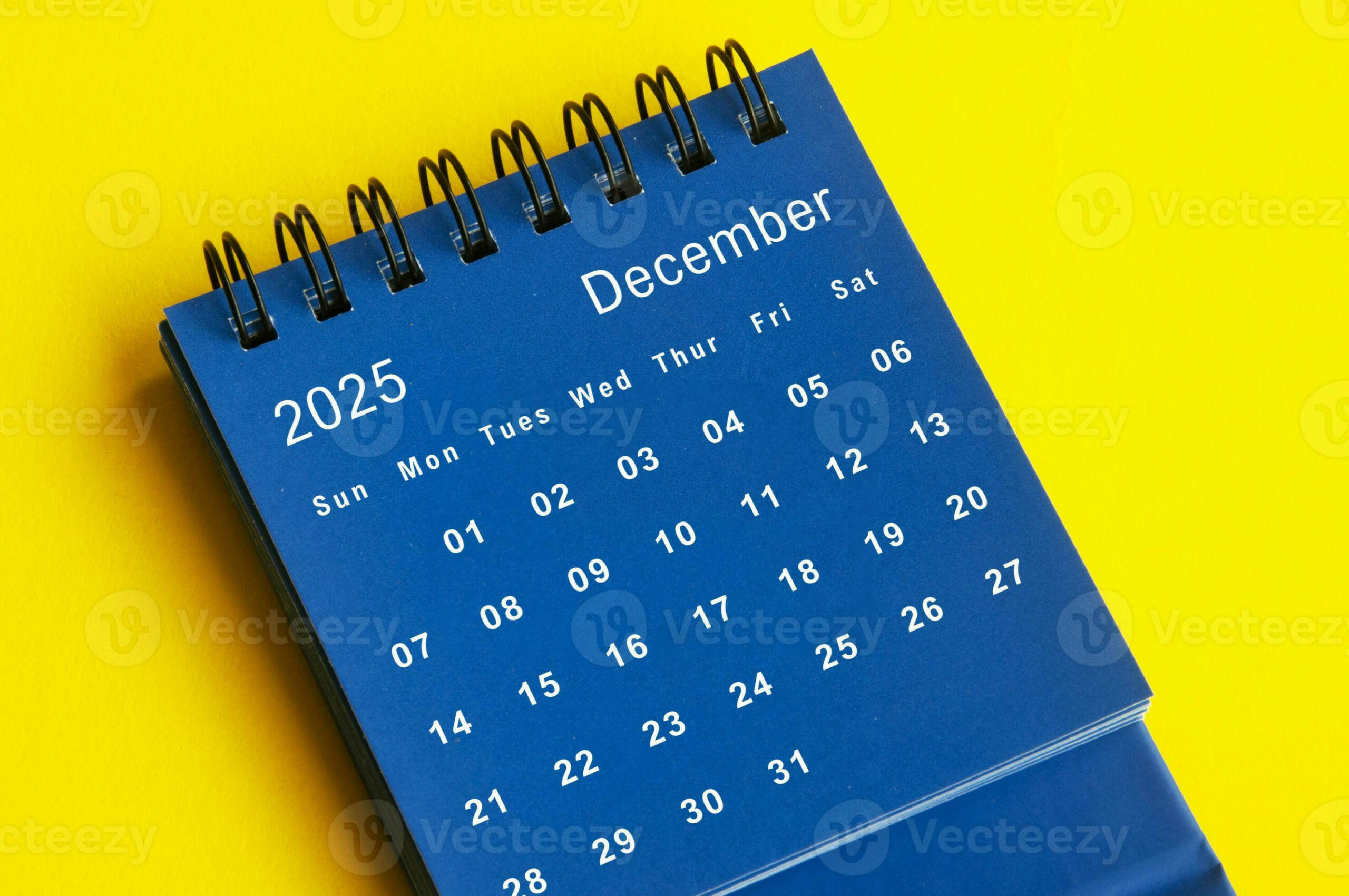 December  blue desk calendar on yellow cover background