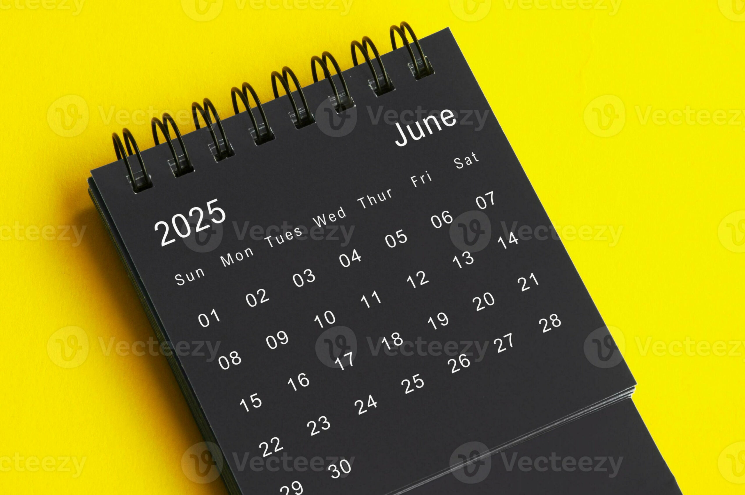 June  black and white desk calendar on yellow cover