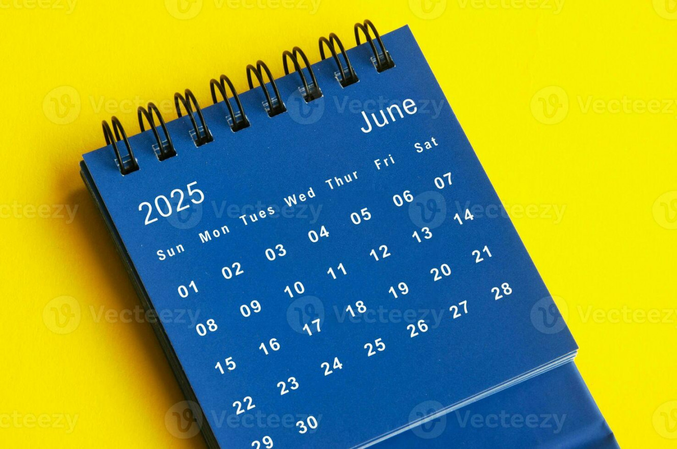 June  blue desk calendar on yellow cover background