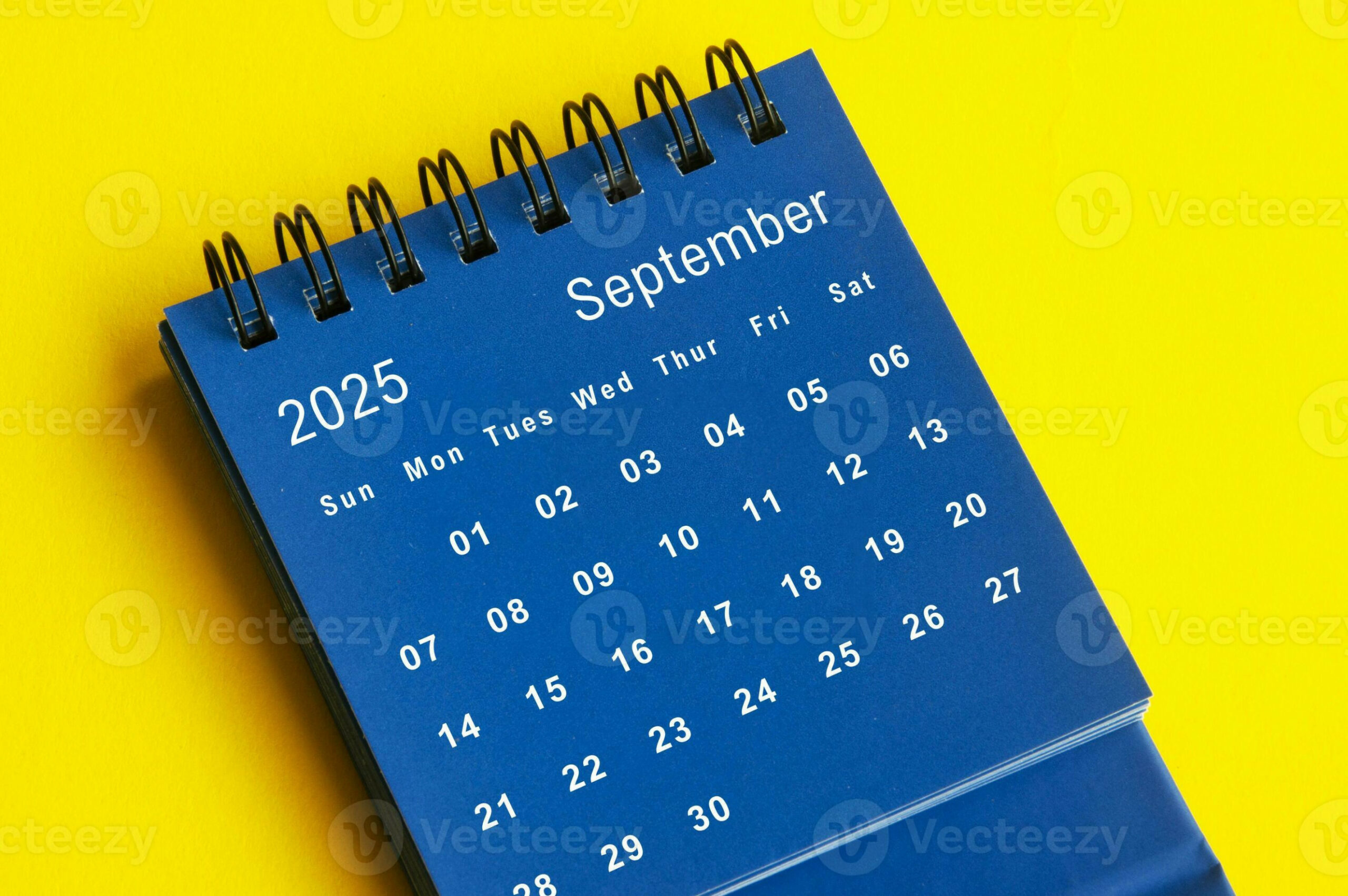 September  blue desk calendar on yellow cover background