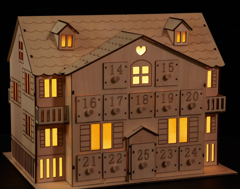 A reusable wooden advent calendar in the shape of a festive house