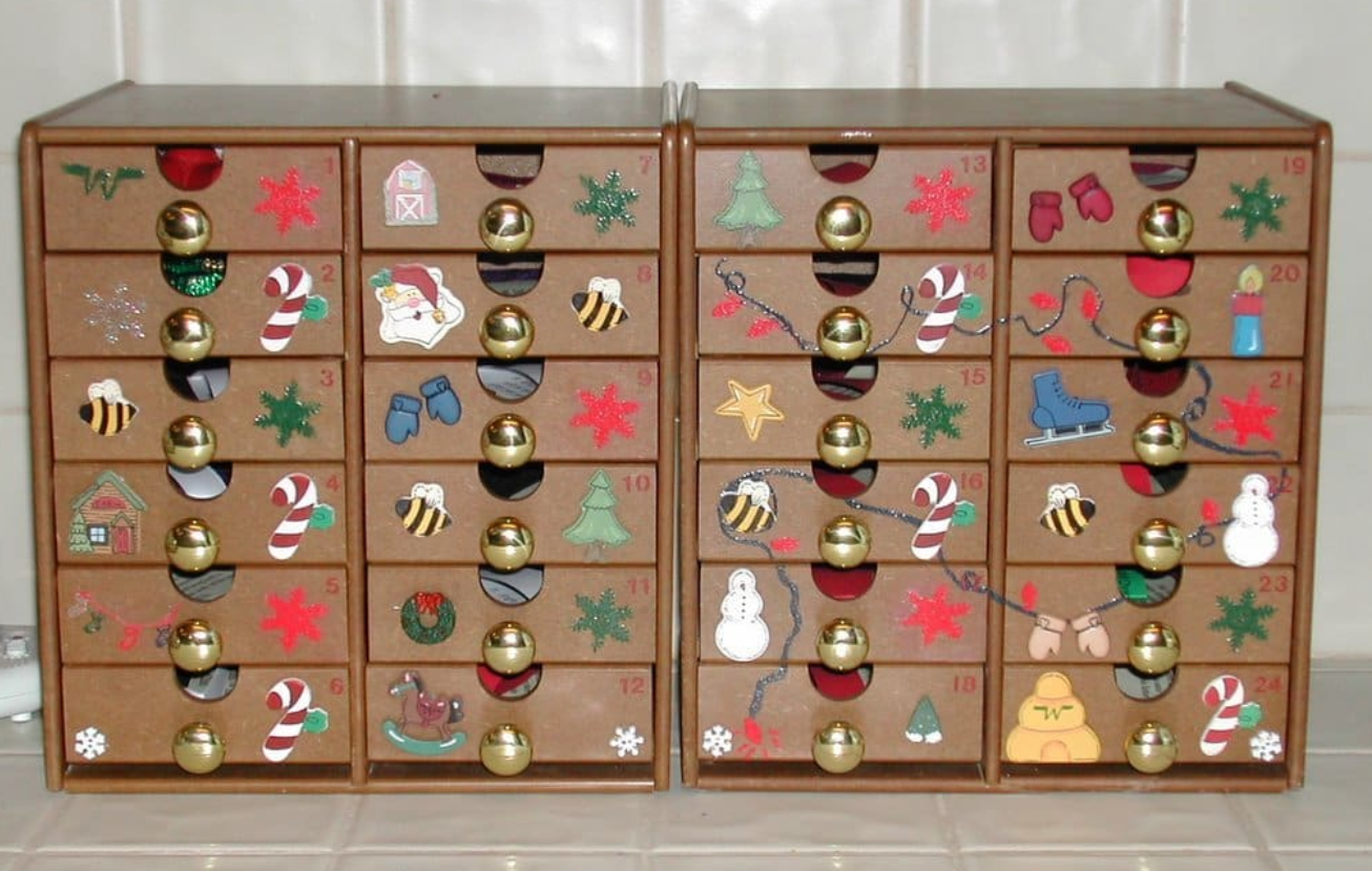 eco friendly gift into a drawer of a wooden reusable advent calendar for a personalized family tradition